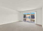 Thumbnail 47 of 54 - an empty living room with a door to a balcony at Camino de Oro Apartments, Torrance, CA, 90505