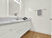Thumbnail 48 of 54 - a bathroom with a sink and a mirror at Camino de Oro Apartments, Torrance, CA, 90505