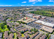 Thumbnail 17 of 36 - an aerial view of a city with a parking lot and buildings at Casa Del Amo Apartments, California