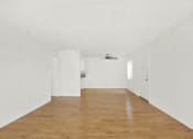 Thumbnail 33 of 36 - an empty living room with white walls and a ceiling fan at Casa Del Amo Apartments, California, 90505
