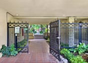 Thumbnail 3 of 26 - the entrance to a building with a gate and a courtyard at Casa De Oro Apartments, Torrance