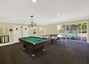 Thumbnail 9 of 26 - a game room with a pool table and a ping pong table at Casa De Oro Apartments, Torrance, CA 90505