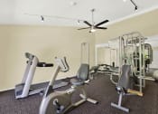 Thumbnail 8 of 26 - a gym with various exercise equipment on the floor at Casa De Oro Apartments, California, 90505