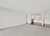Thumbnail 25 of 26 - an empty living room with white walls and a ceiling fanat Casa De Oro Apartments, Torrance California