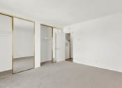 Thumbnail 26 of 26 - an empty living room with white walls and mirrored closet doors at Casa De Oro Apartments, Torrance, 90505