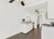 Thumbnail 23 of 26 - a kitchen with white cabinets and a counter top at Casa De Oro Apartments, Torrance, CA 90505