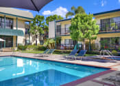 Thumbnail 5 of 36 - a swimming pool in front of an apartment building at Copa Ladeene Apartments, Torrance