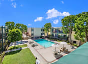 Thumbnail 6 of 36 - a view of the pool at an apartment building with a swimming pool at Copa Ladeene Apartments, California, 90505