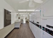 Thumbnail 13 of 36 - a classroom with white cabinets and counters and a ceiling fan at Copa Ladeene Apartments, Torrance, 90505