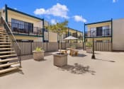 Thumbnail 16 of 36 - a courtyard with tables and chairs and stairs at Copa Ladeene Apartments, California, 90505