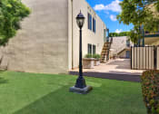 Thumbnail 10 of 36 - a yard with a lamp post in front of a house  at Copa Ladeene Apartments, Torrance, CA 90505