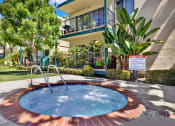 Thumbnail 3 of 36 - a jacuzzi in the yard of a house with a building in the at Copa Ladeene Apartments, Torrance, CA