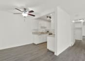Thumbnail 19 of 36 - an empty living room and kitchen with a ceiling fan at Copa Ladeene Apartments, Torrance