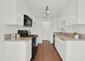 Thumbnail 25 of 36 - a kitchen with white cabinets and a counter top at Copa Ladeene Apartments, Torrance, 90505
