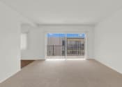 Thumbnail 27 of 36 - the living room of an empty apartment with a balcony at Copa Ladeene Apartments, Torrance California