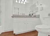Thumbnail 34 of 36 - a bathroom with a toilet and a sink and a mirror at Copa Ladeene Apartments, California, 90505