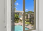 Thumbnail 35 of 36 - a view of the pool from a window at Copa Ladeene Apartments, Torrance California