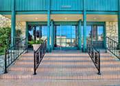 Thumbnail 18 of 36 - the entrance to a building with stairs and railings at Copa Ladeene Apartments, Torrance California