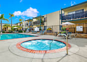 Thumbnail 5 of 26 - our apartments have a swimming pool and a patio with chairs and umbrellas at Copa Triana Apartments, Torrance California