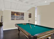Thumbnail 10 of 26 - a games room with a pool table and paintings on the wall at Copa Triana Apartments, Torrance, CA 90505