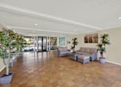 Thumbnail 9 of 26 - a large living room with a couch and a table at Copa Triana Apartments, Torrance, CA