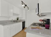 Thumbnail 18 of 26 - a kitchen with granite counter tops and white cabinets at Copa Triana Apartments, Torrance, 90505