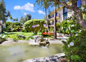 Thumbnail 10 of 55 - a spa with a fountain in the middle of a garden at Willow Tree Apartments, Torrance