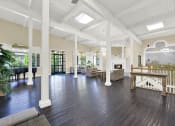 Thumbnail 17 of 55 - a large living room with a fireplace and a staircase at Willow Tree Apartments, Torrance, CA