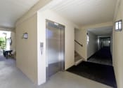 Thumbnail 21 of 55 - a metal elevator in a hallway of a building  at Willow Tree Apartments, Torrance, CA, 90505