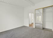 Thumbnail 32 of 55 - an empty room with a mirror and carpet at Willow Tree Apartments, California, 90505