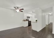 Thumbnail 25 of 55 - a living room and kitchen with a ceiling fan at Willow Tree Apartments, Torrance, CA, 90505