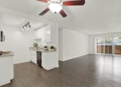 Thumbnail 23 of 55 - an empty living room and kitchen with a ceiling fan at Willow Tree Apartments, Torrance, CA