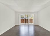 Thumbnail 31 of 55 - an empty living room with a sliding glass door to a balcony at Willow Tree Apartments, Torrance, CA