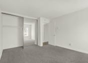 Thumbnail 34 of 55 - the living room of an apartment with white walls and carpet  at Willow Tree Apartments, California, 90505