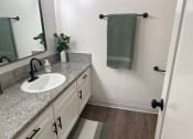 Thumbnail 42 of 55 - a bathroom with a sink and a mirror and a towel at Willow Tree Apartments, California, 90505