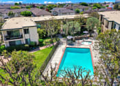 Thumbnail 3 of 36 - a backyard with a swimming pool and a house at Casa Del Amo Apartments, Torrance, CA 90505