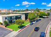 Thumbnail 6 of 36 - an aerial view of a building with cars parked in front of it at Casa Del Amo Apartments, California