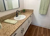 Thumbnail 46 of 55 - A bathroom with a sink and a mirror at Willow Tree Apartments, California, 90505
