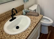 Thumbnail 47 of 55 - A bathroom with a sink, toilet, and mirror at Willow Tree Apartments, California, 90505