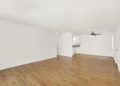 Thumbnail 27 of 36 - an empty living room with wood flooring and a ceiling fan at Casa Del Amo Apartments, Torrance, CA
