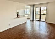 Thumbnail 16 of 18 - A room with wooden floors and a window with blinds at Royal Towers Apartments, Redondo Beach, CA, 90277