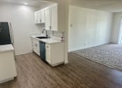 Thumbnail 27 of 54 - A kitchen with white cabinets and a black fridge. at Camino de Oro Apartments, Torrance, CA, 90505