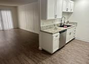 Thumbnail 52 of 54 - A kitchen with white cabinets and a granite countertop.