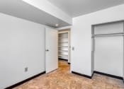 Thumbnail 4 of 10 - an empty room with white walls and a closet with a door