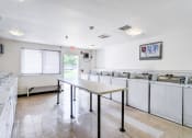 Thumbnail 5 of 10 - a kitchen with a table and counters and a sink