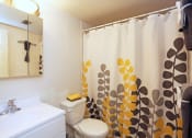 Thumbnail 23 of 25 - a bathroom with a shower curtain and a sink and a toilet