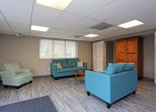 Thumbnail 21 of 25 - a waiting room with blue couches and chairs