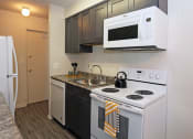Thumbnail 4 of 25 - a kitchen with white appliances and a sink and a white microwave