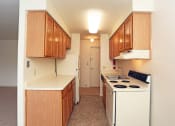 Thumbnail 22 of 25 - a kitchen with white appliances and wooden cabinets