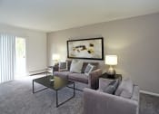 Thumbnail 11 of 25 - a living room with a couch and a table